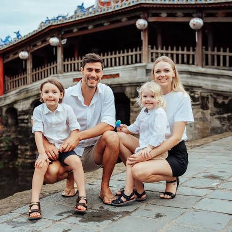 Family with two young children by the Japanese Bridge in Hoi An