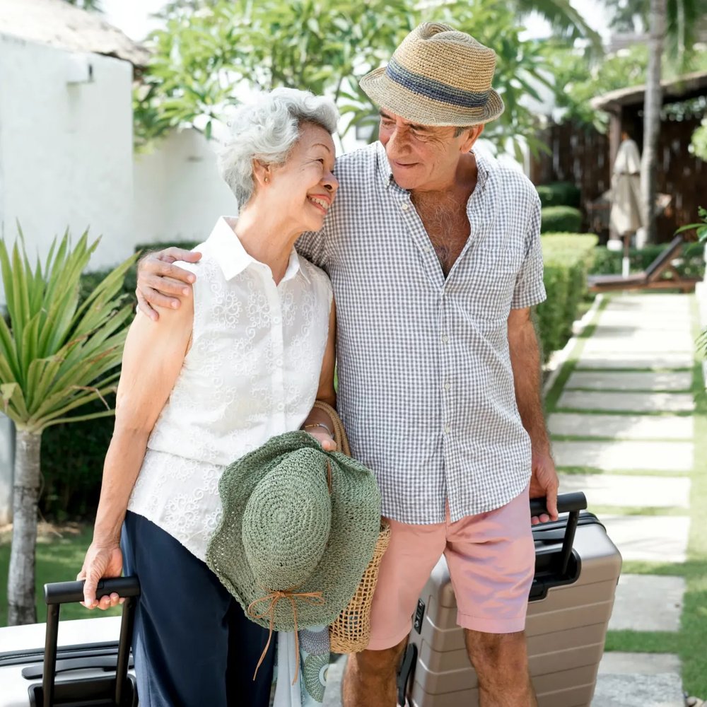 Couple arriving with their suitcases at their new home